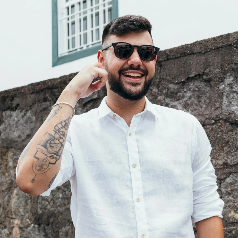 a smiling man wearing sunglasses