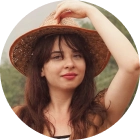 round avatar of a female with a vacation hat